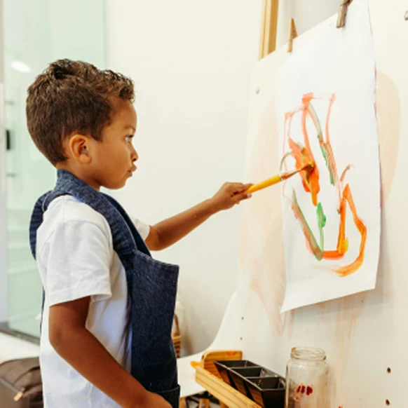 A child painting at an easel