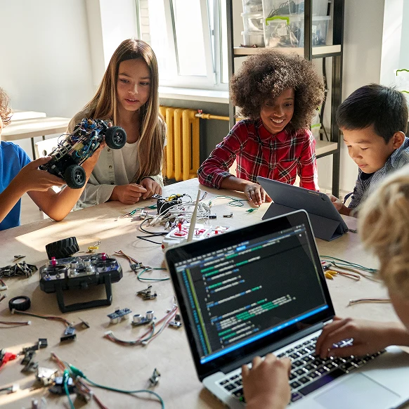 Children building a robot together in a classroom