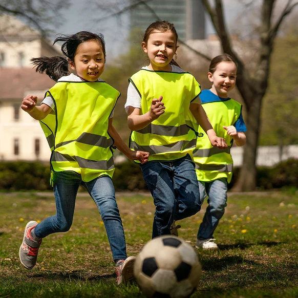 Children playing football outdoors